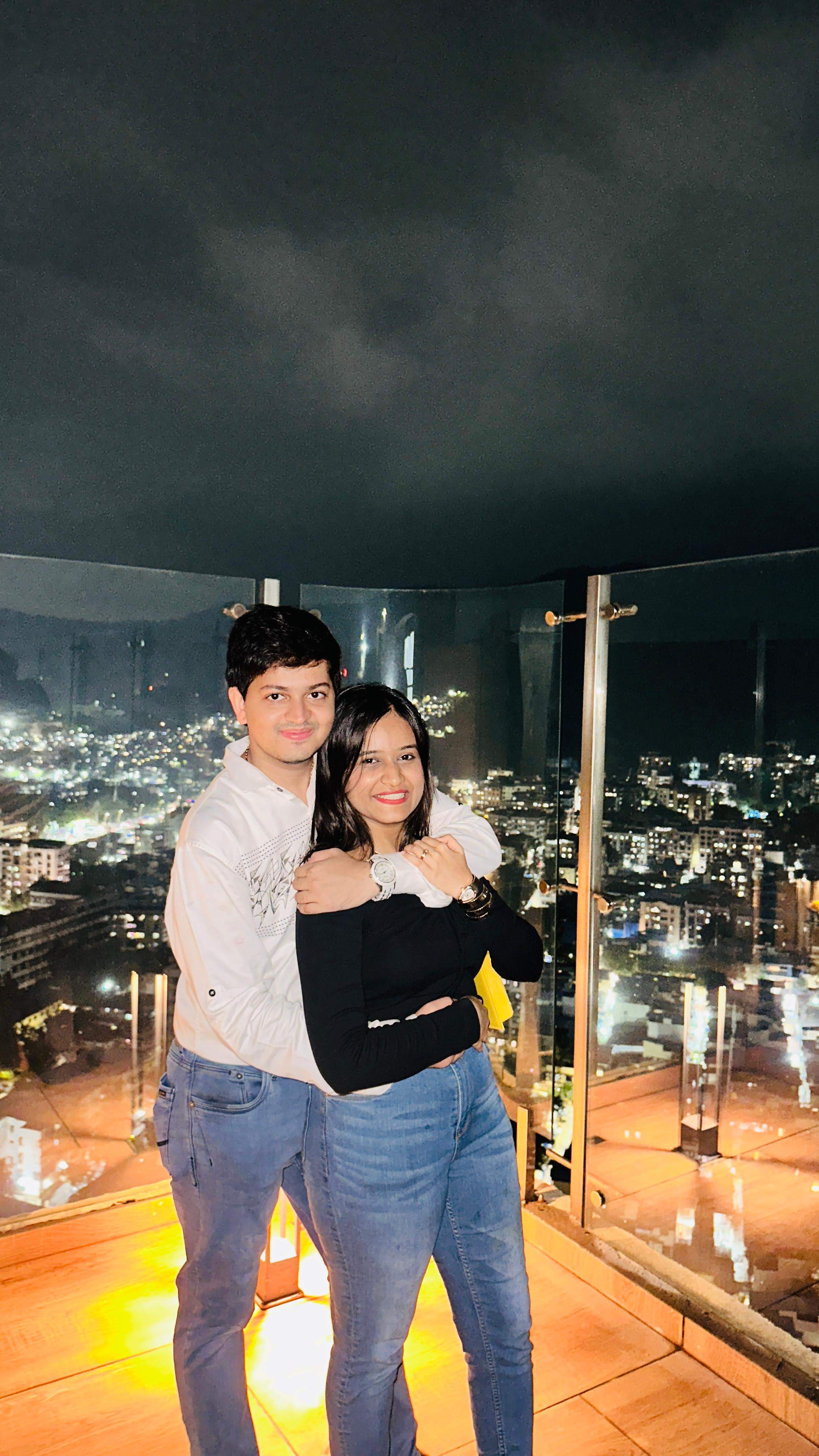 Manas holding deepanshi on rooftop terrace, night scene